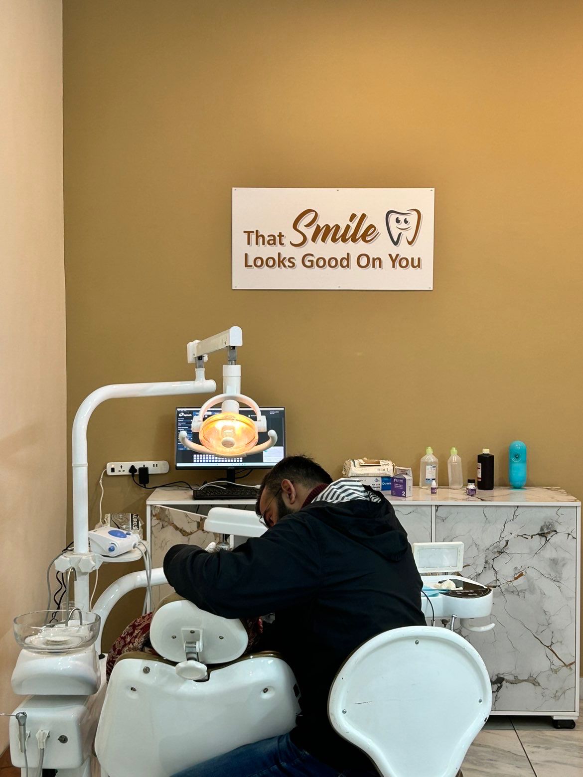 Dentist gently treating a patient at Malhi Dental Co.