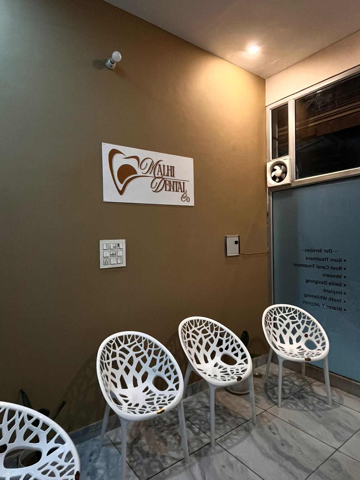 Waiting area with services list on glass